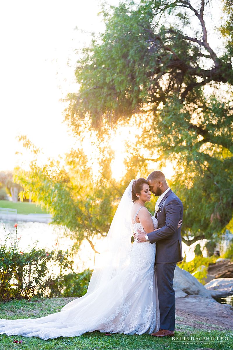 Newlyweds share a quiet moment by the water at their Casa de Lago wedding in Orange, CA