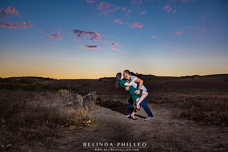 Orange County engagement photography by Belinda Philleo. Couple shares a kiss at sunset in Thomas F. Riley Wilderness park, Coto De Caza, CA
