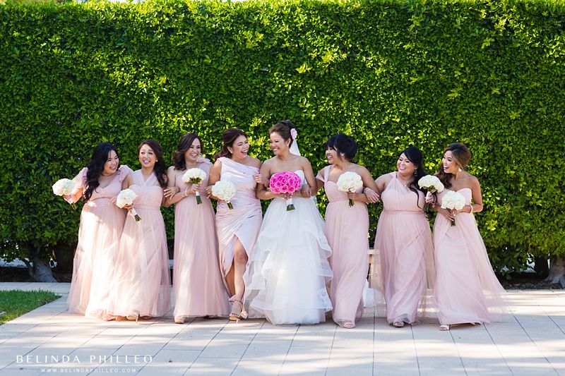 Bride and her bridesmaids share a laugh at Cerritos Library Sculpture Garden in Cerritos, CA