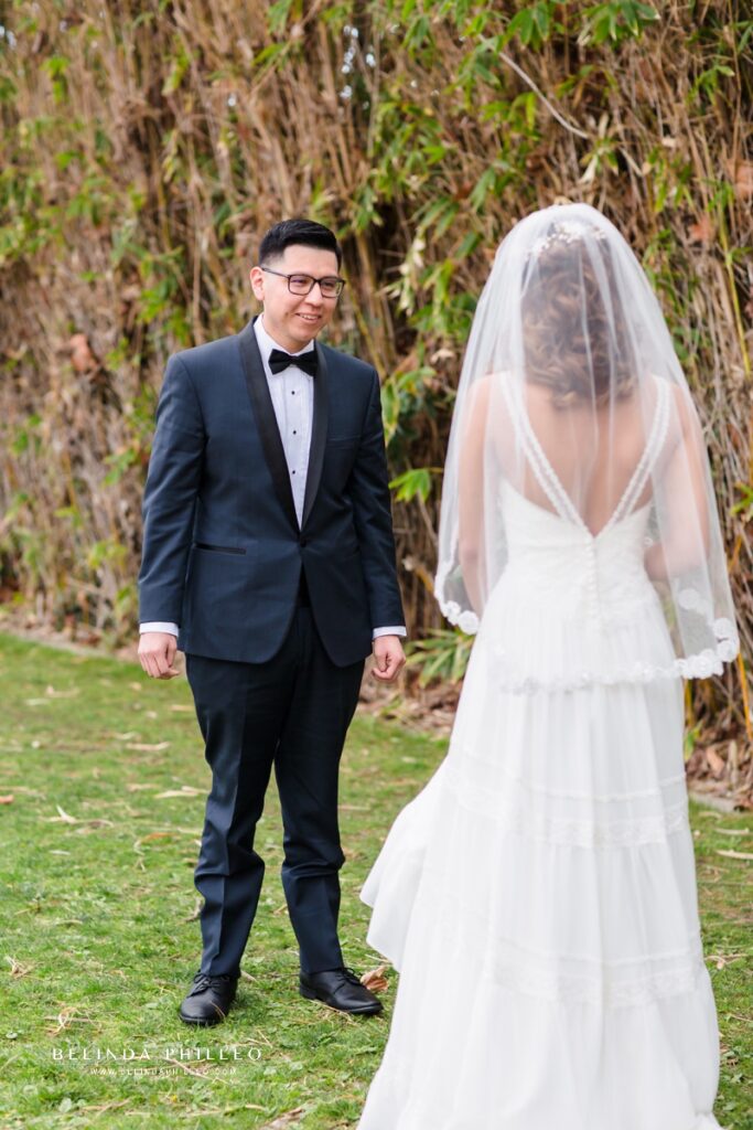 Groom admires his bride's Justin Alexander bridal gown