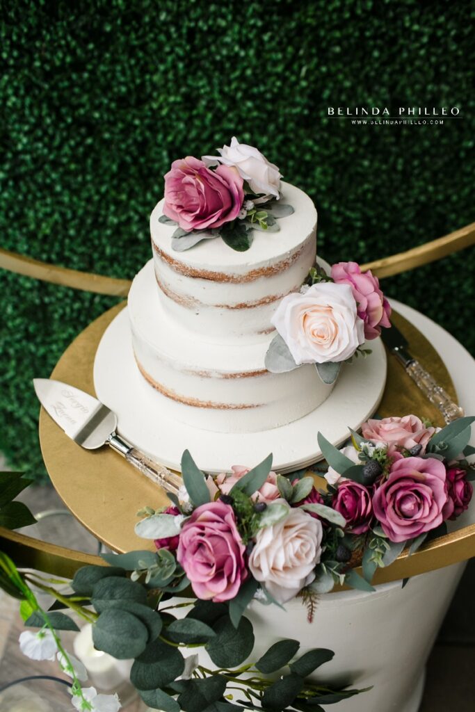 White naked cake with mauve and white flowers