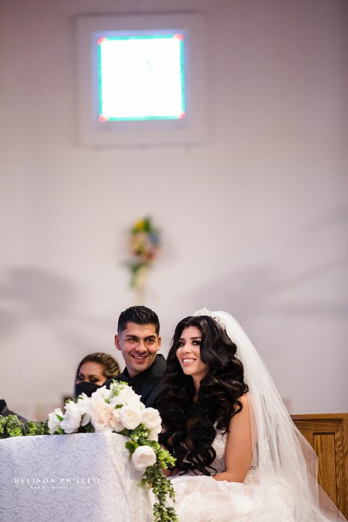 Groom smiles at his new bride during their wedding ceremony in California. Photography by Belinda Philleo