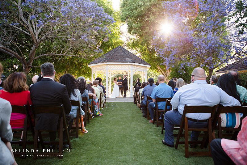 Sunlight shines through the trees at Heritage Museum of Orange County wedding ceremony in Santa Ana, CA. Photography by Belinda Philleo