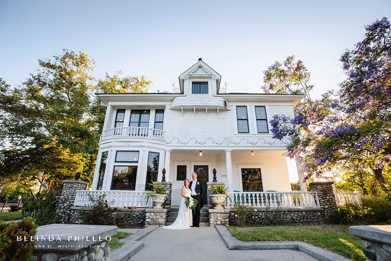 Bride and groom pose for a picture in front of the Kellogg House at the Heritage Museum of Orange County in Santa Ana, CA. Photo by Belinda Philleo