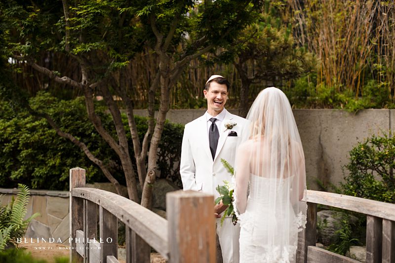 Bride and groom share their first look on the garden bridge at JACCC in Los Angeles, Ca