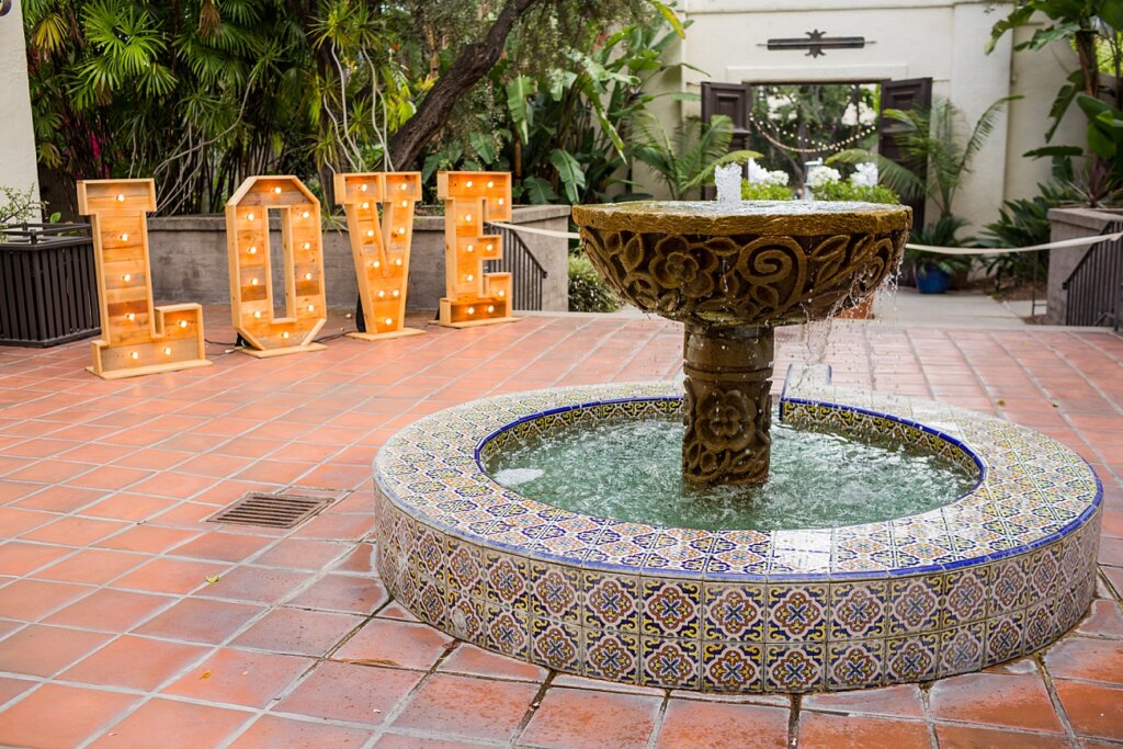 Giant "LOVE" marquee greets wedding guests at the entrance of Los Angeles River Center & Gardens wedding in Cypress Park, CA