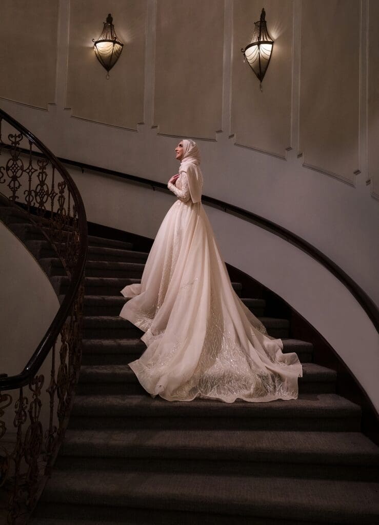 Bride poses on the staircase during her wedding at Brandview Ballroom in Glendale, CA